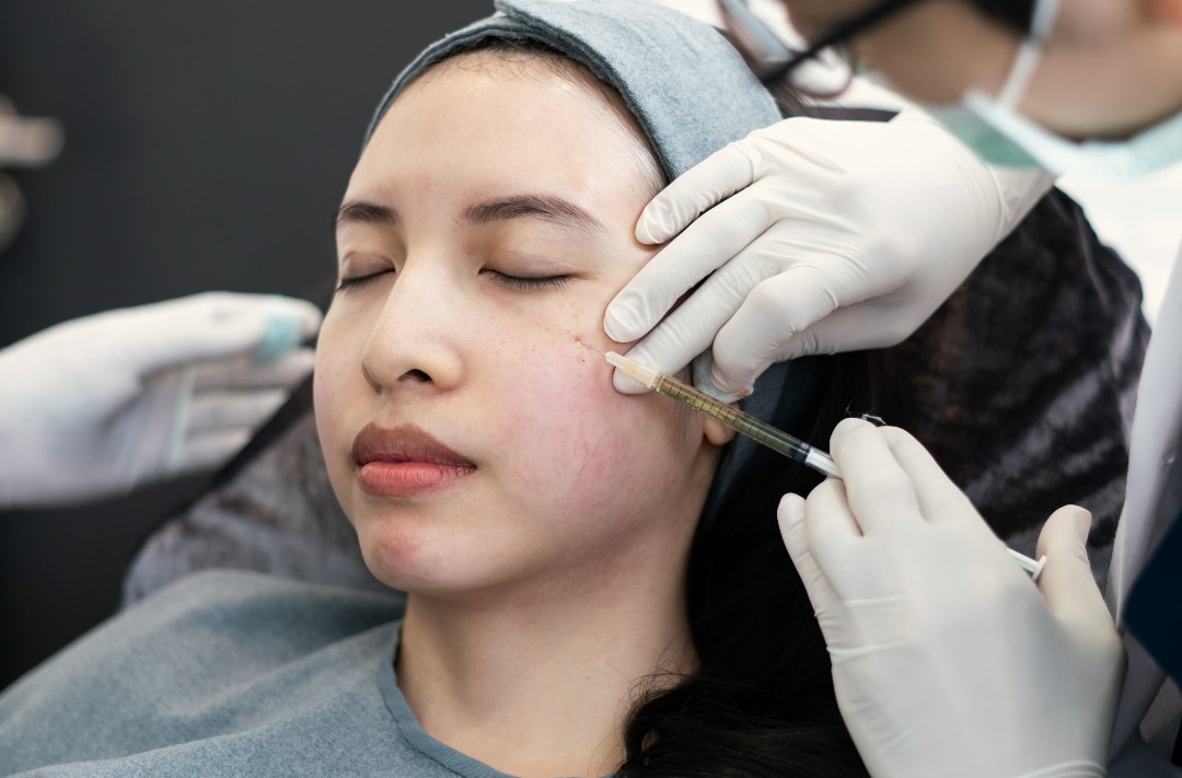 woman getting rejuran treatment on her face