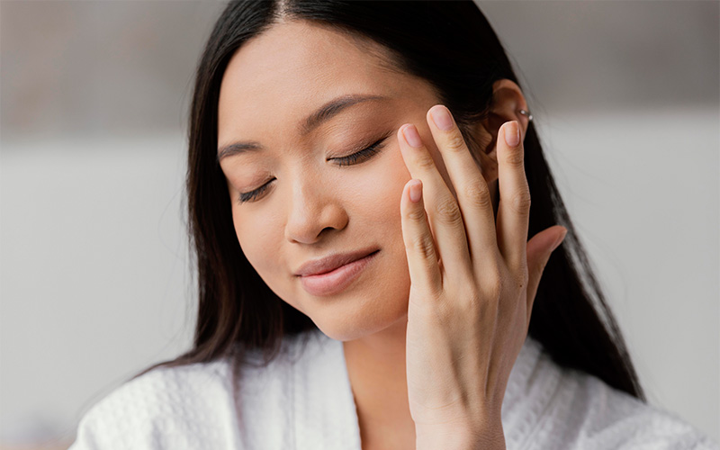 A close-up of a smiling woman with clear, healthy skin and high skin density