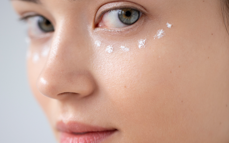 Applying skincare product dots to care for crow's feet.